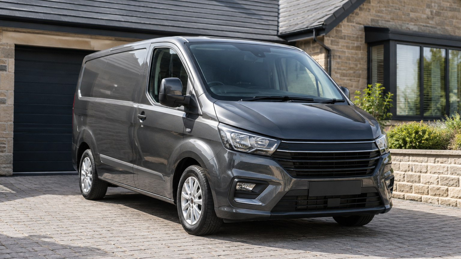 Illustrative photograph of a modern van parked on a UK driveway in natural daylight.