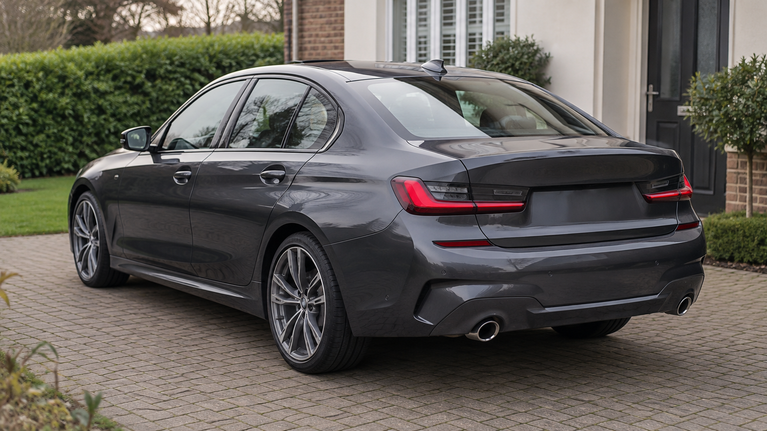 Illustrative photograph of a BMW 330d saloon parked on a UK driveway in natural daylight.