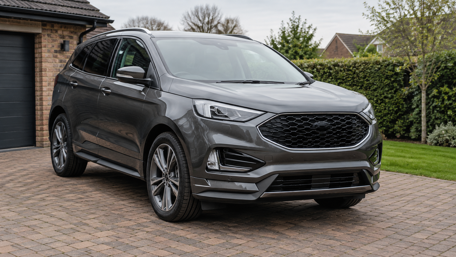 Illustrative photograph of a grey Ford Edge parked on a residential driveway in England.